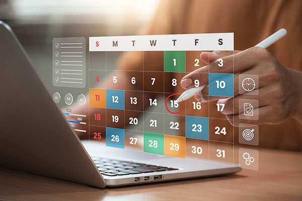 A person plans his month on a calendar