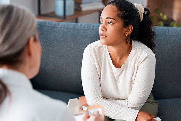 A girl is sitting on the couch at a therapist's appointment
