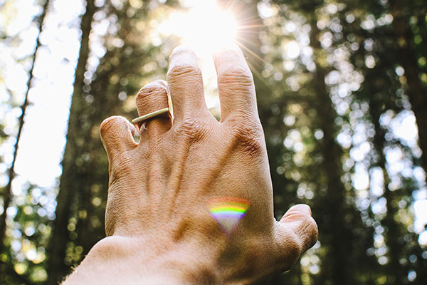 the man stretched out his hand to the moon on the background of the green forest